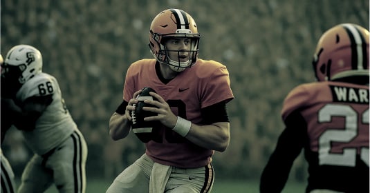 Quarterback holding football in game
